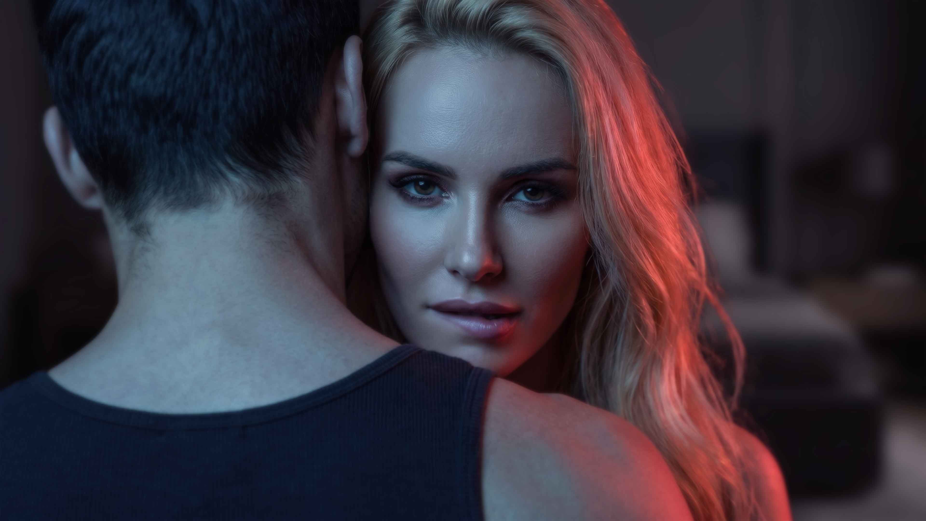 male and femal supermodels in loving embrace seen from behind